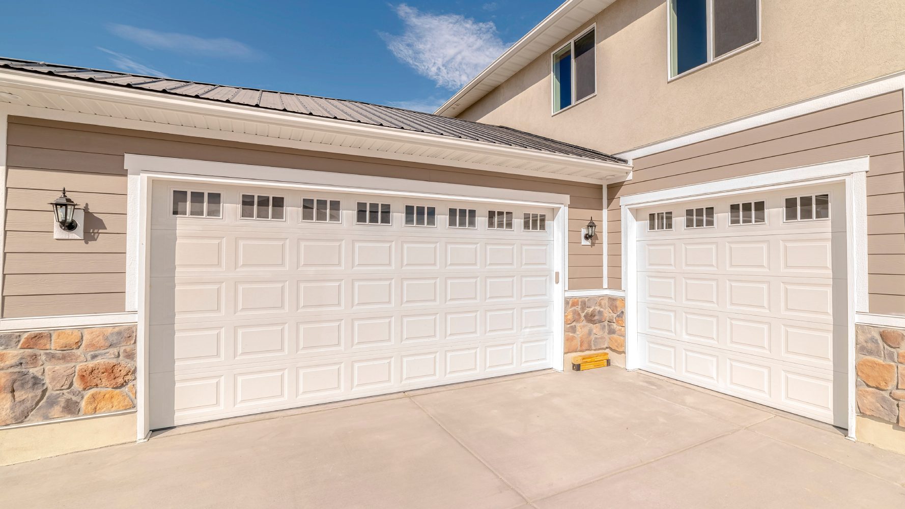 Garage door installation in Denver, showcasing a technician working on a modern garage door in a residential setting.