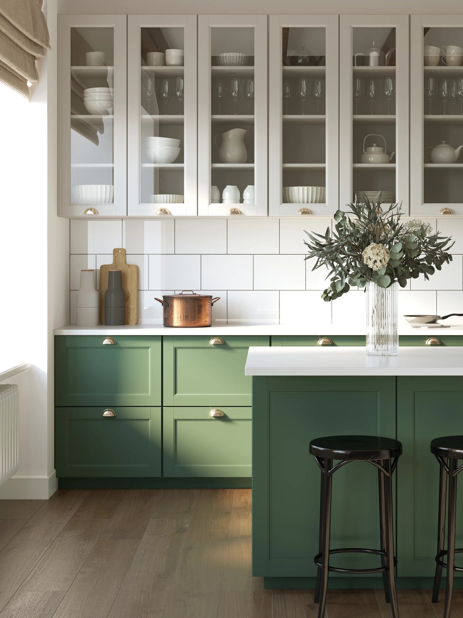 Bright kitchen with green cabinets and white countertops. Glass cabinets display dishes. A vase with flowers sits on the island, creating a fresh, elegant mood.