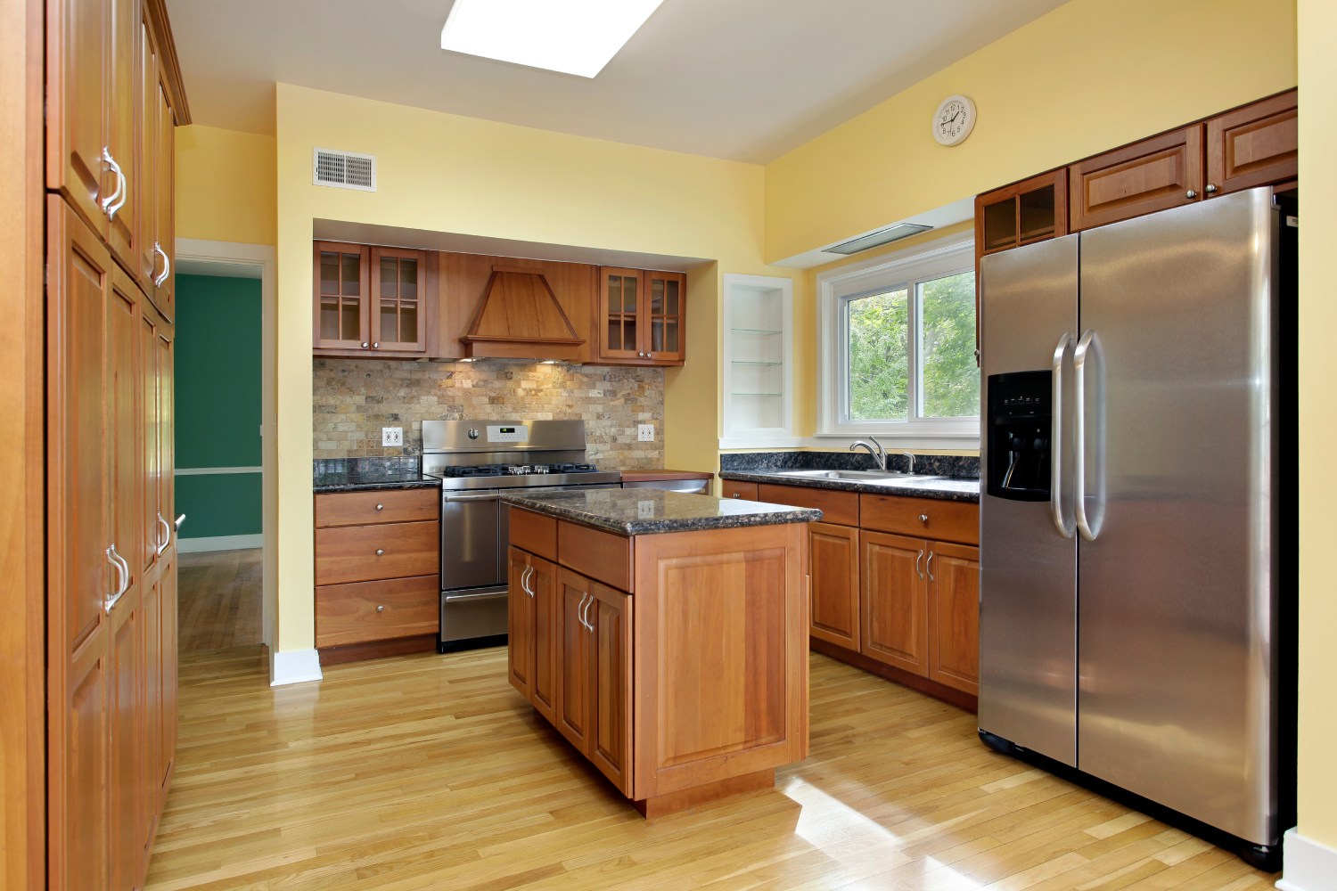 A well-equipped kitchen with a refrigerator and stove, highlighting essential appliances for meal preparation.